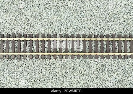 Fine grey gravel background used as track ballast for model railways with section of track Stock Photo
