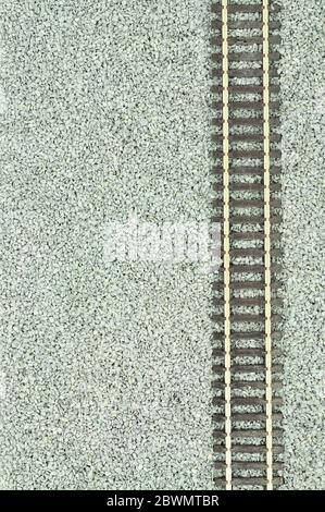 Fine grey gravel background used as track ballast for model railways with section of track Stock Photo