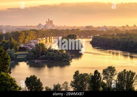 Belgrade / Serbia - May 30, 2020: Belgrade cityscape and confluence of rivers Danube and Sava at golden hour sunset, view from Belgrade Fortress Kalem Stock Photo