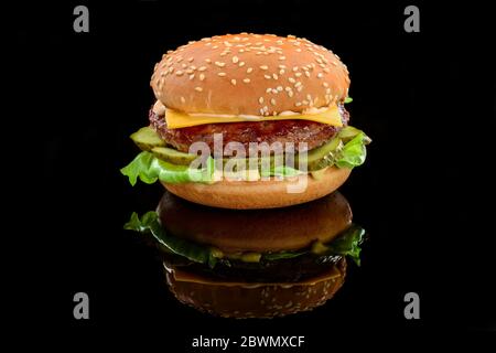 Big tasty hamburger or cheeseburger on black background Stock Photo
