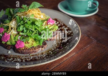 Avocado Sandwich with with beet hummus - sliced avocado and humus on rye toasted bread for healthy breakfast or snack Stock Photo