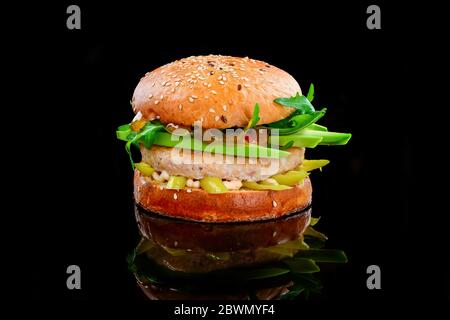 Chicken burger with avocado on a black background Stock Photo