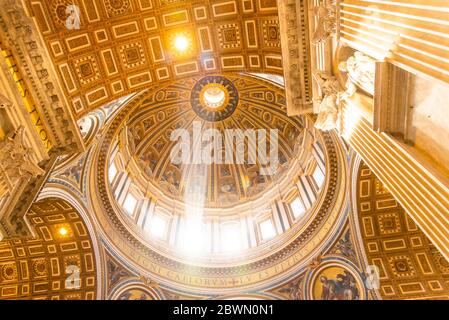 VATICAN CITY - MAY 07, 2019: Ray of light in the dome. Interior of the Saint Peters Basilica, Vatican in Rome, Italy. Stock Photo