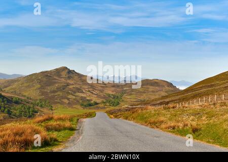 GENERAL WADE'S MILITARY ROAD ON THE SOUTH SIDE OF LOCH NESS SCOTLAND FROM HILL ABOVE LOCH TARFF LOOKING TOWARDS BEN NEVIS MOUNTAIN RANGE Stock Photo