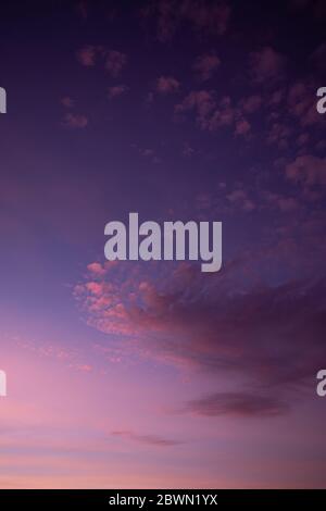 BEAUTIFUL sunset with purple sky and few clouds Stock Photo