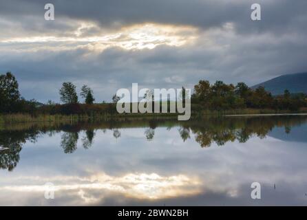 Reflection of Cherry Mountain in Airport Marsh, near Mt Washington Regional Airport, in Whitefield, New Hampshire USA a foggy morning. Stock Photo