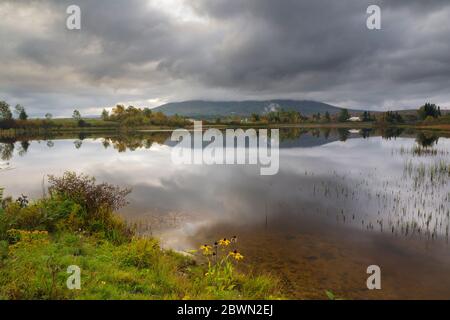 Reflection of Cherry Mountain in Airport Marsh, near Mt Washington Regional Airport, in Whitefield, New Hampshire on a cloudy morning. Stock Photo