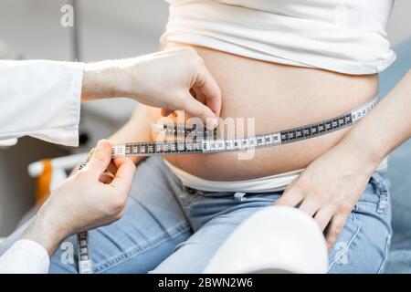 Measuring pregnant woman's stomach hi-res stock photography and