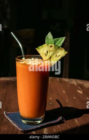 Papaya smoothie in glass on table in tropical cafe Stock Photo