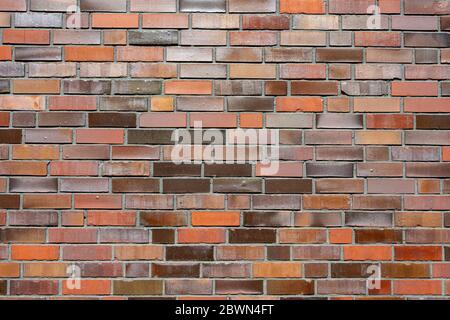 Background from a brick wall with different red tones Stock Photo