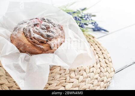 Easter cake on the plate and flowers on wooden background Stock Photo