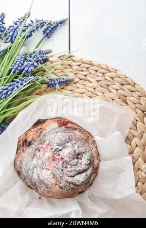 Easter cake on the plate and flowers on wooden background Stock Photo