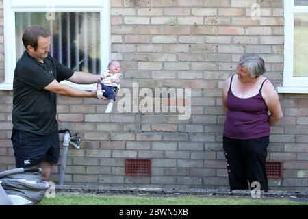 Pengam, South Wales. 02nd June, 2020. Angela Morgan (right) from Pengam, near Caerphilly, South Wales meets her 1st Grandchild Mike, born 2 weeks ago today as her son in law John (l) visit after lockdown restrictions were eased in Wales yesterday allowing families to meet up outside . pic by Andrew Orchard/Alamy Live News Stock Photo