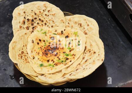Homemade Butter Naan isolated on black background Stock Photo