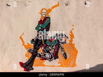 Graffiti of ghost rider with his bike on a wall of a cafe in Ladakh, India. Natural beauty of Ladakh in India. Snow mountains of Ladakh. Famous Ladakh. Stock Photo