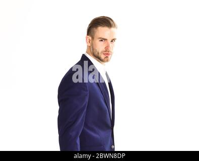 Confident elegant handsome young business man standing in front of white background in a studio wearing a nice suit Stock Photo