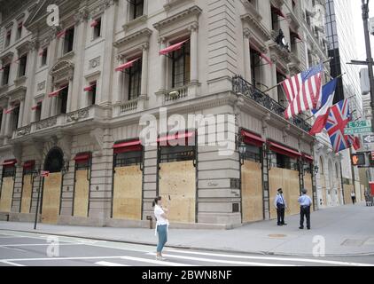 A Cartier retail store on Fifth Avenue is boarded up after a long