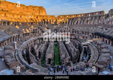 The Colosseum Arena - A wide-angle sunset overview of the arena and hypogeum surrounded by ancient high walls inside of the Colosseum. Rome, Italy. Stock Photo