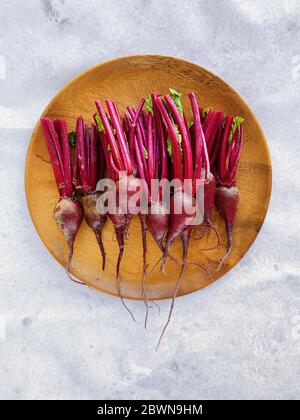 Flat lay image of fresh and young beetroots on the wooden bowl. Image made on mobile phone Stock Photo