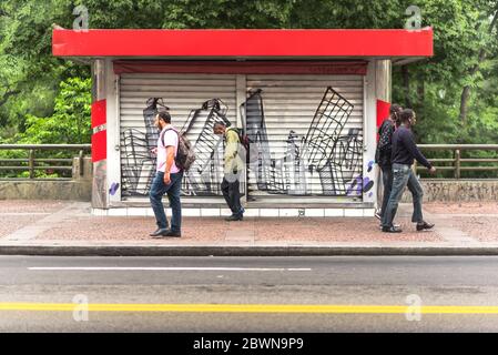 Random people walking in front of a news stand Stock Photo