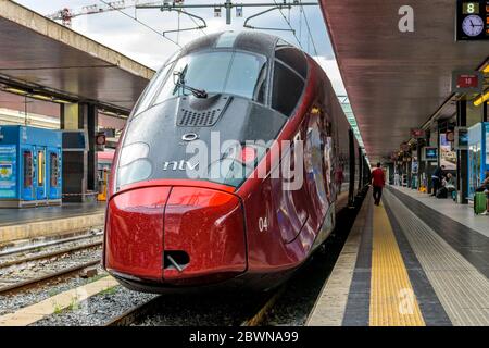 Red High-Speed Train - Front view of a red modern high-speed electric train, Alstom AGV 575 of NTV, parking in Rome Termini Train Station. Rome, Italy. Stock Photo