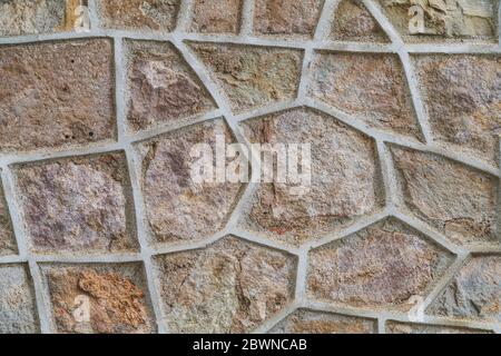 Background of an old natural stone wall with concrete divider shapes Stock Photo