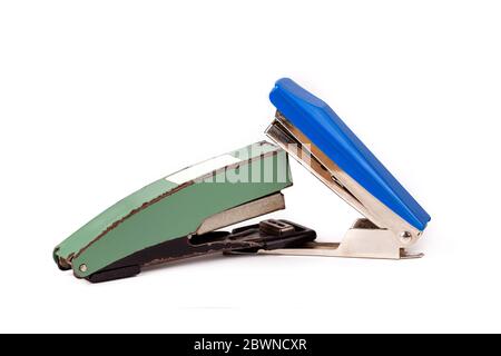 Two staplers fighting, stapling, biting each other. New vs old fight, new winning Office war, desk accessories duel, brawl, conflict funny abstract Stock Photo