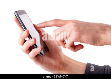 Tapping on something on a blank empty smartphone screen. Hand holding mobile phone, pointing finger tap gesture seen from the side, isolated on white Stock Photo