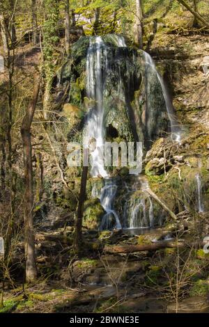 Waterfall with water flowing over a rock formation that is shaped like a skull, long exposure Stock Photo