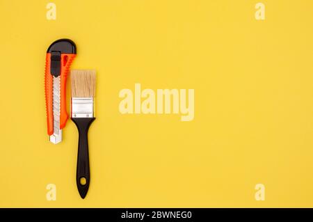 Brush and knife painter on a yellow background. Stock Photo