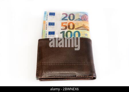 Top view of brown genuine leather wallet with banknotes inside isolated on white background. High quality photo Stock Photo