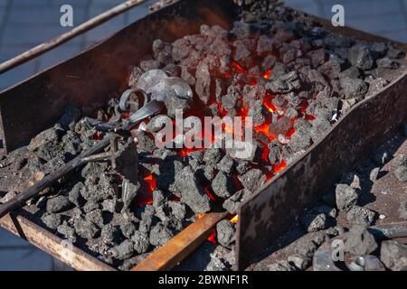Forge, brazier with hot coals, equipment close-up Stock Photo