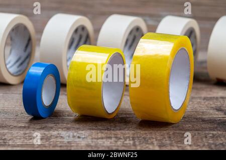 Scotch tape, duct tape, and masking tape on the wood surface. Stock Photo