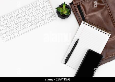 flatlay of White office desk table layout. computer keyboard, glasses, smartphone, laptop case. copy space layout Stock Photo