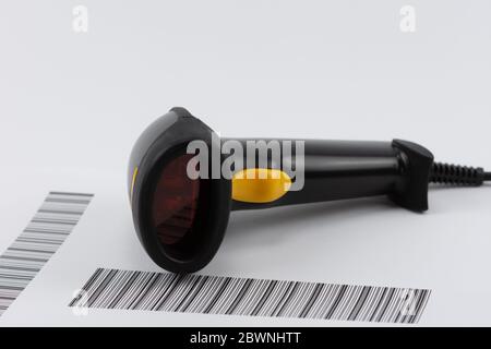 black USB barcode scanner with yellow shutter on barcode list Stock Photo
