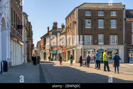 People queueing suitably socially distanced to enter a branch of Lloyds Bank in King's Lynn during the 2020 COVID-19 coronavirus pandemic. Stock Photo