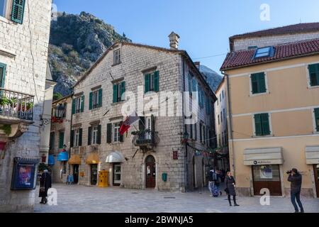Beautiful old building with white windows and green window shutters, Palace of Bizanty family 14-17 century, Kotor, Montenegro Stock Photo