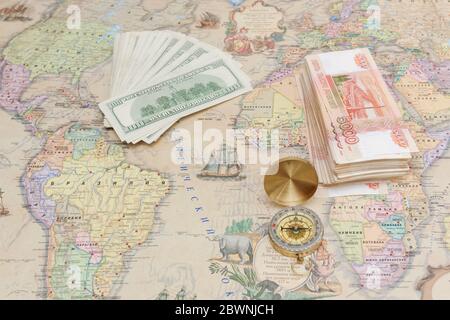 Compass with a bundle of big money are on the map Stock Photo