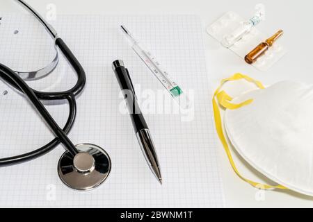 Medical masks with elastic band, thermometer, medicine and stethoscope, Isolated on white background. Healthcare and medical concept. High quality photo Stock Photo