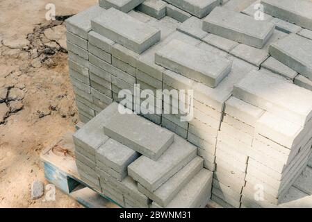 Paving tile stack on the street. Construction materials for site improvement. Stock Photo