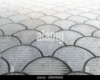 Grey pedestrian road lined with gray paving tiles Stock Photo
