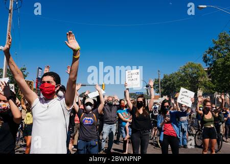 Protesters hold up their hands in a moment of silence in front of the Minneapolis police 5th precinct, Saturday, May 30, 2020 Stock Photo