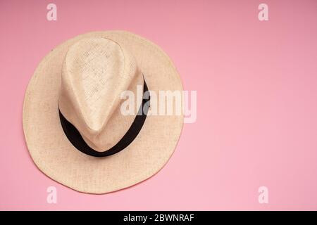 Straw hat on a pink background. Conceptual photo. Close-up. Copy space. Stock Photo