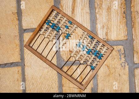 Old abacus on a stone wall.Decor Object. Stock Photo