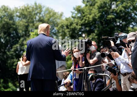U.S. President Donald Trump takes questions from the press on the South Lawn of White House prior to boarding Marine One May 30, 2020 in Washington, DC. Trump is traveling to  Cape Canaveral to view the launch of the SpaceX Crew capsule. Stock Photo