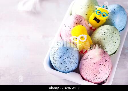 Organic colorful easter eggs in porcelain decorative box on white. Holiday Easter concept . Stock Photo