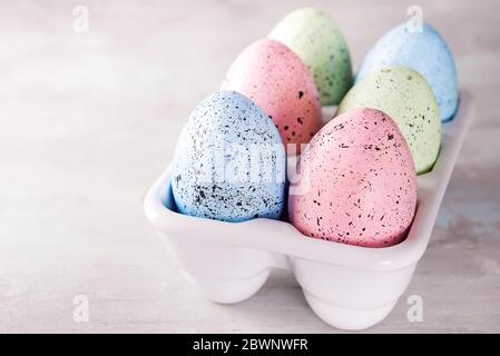 Organic colorful easter eggs in porcelain decorative box on white. Holiday Easter concept . Stock Photo