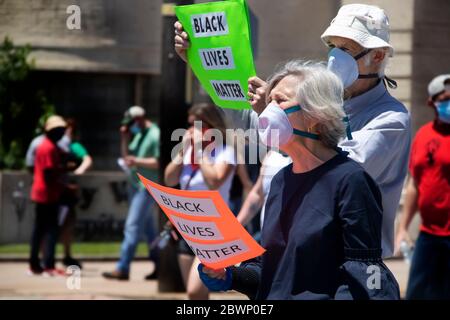 05-30-2020 Tulsa OK Senior couple marching in Black Lives Matter rally with signs and masks