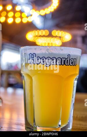 Belgrade / Serbia - November 17, 2019: Cup of Hoegaarden Belgian wheat beer on a table in a bar Stock Photo