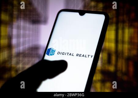 In this photo illustration the Digital Realty Trust logo seen displayed on a smartphone. Stock Photo
